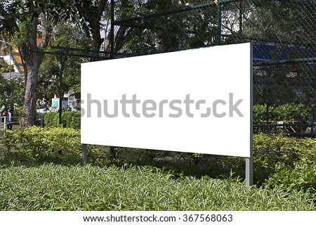 blank billboard in green park field at city park zone