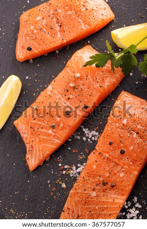 Fresh raw salmon fillet and aromatic spices for baking





