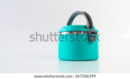Modern and simplistic greenish blue color lunch box. Isolated on empty background. Slightly de-focused and close-up shot. Copy space.