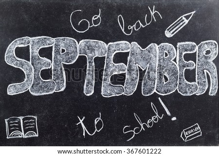 Handwritten September with go back to school, book eraser and pencil on black chalkboard