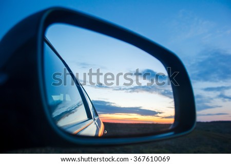 Blue landscape sunset reflect in mirror of car Royalty-Free Stock Photo #367610069