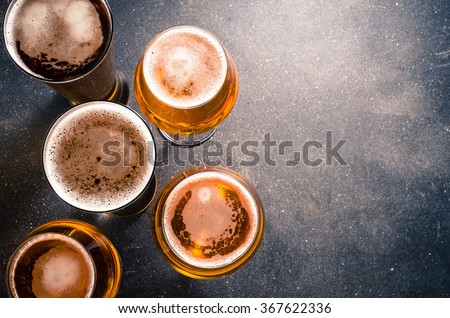 Beer glasses on dark table Royalty-Free Stock Photo #367622336