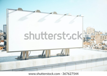 Blank billboard on the roof of building at megapolis city background, mock up