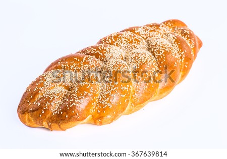 Two whole fresh challah bread with poppy and sesame seeds on a white background