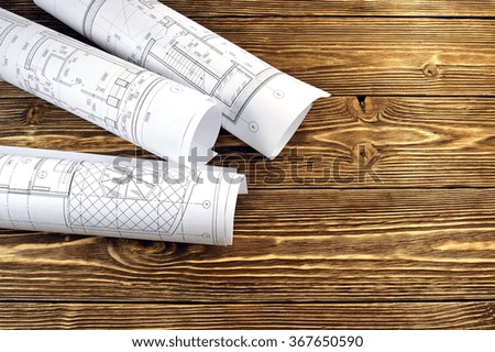 Photo drawings for the project engineering work that lie on background a wooden table