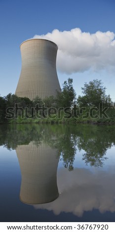 A photography of a cooling tower at the lake