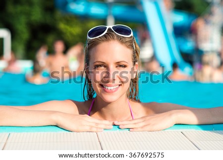Beautiful young woman in the swimming pool