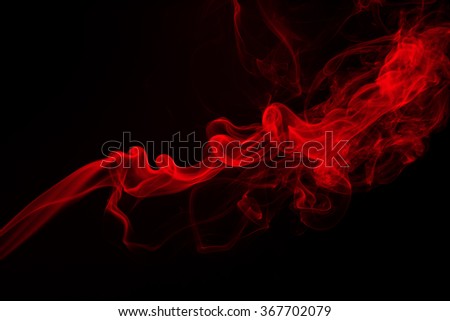 Fluffy puffs of red smoke and fog on black background, fire design and darkness concept