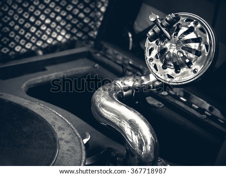 Vintage gramophone play the old music. Old gramophone closeup - retro photo in black and white colors.
