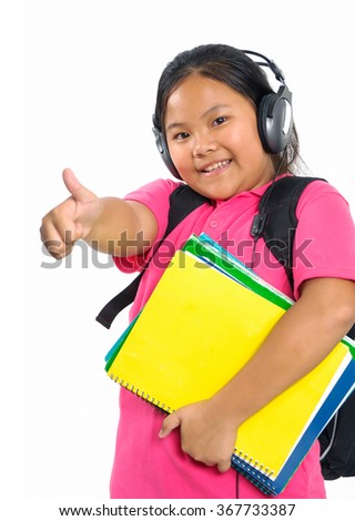 Teenage girl listening to music with book 