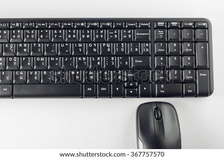 Computer mouse and keyboard on white background.