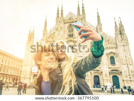 Couple taking self portrait in Duomo square. Concept about traveling and relationship