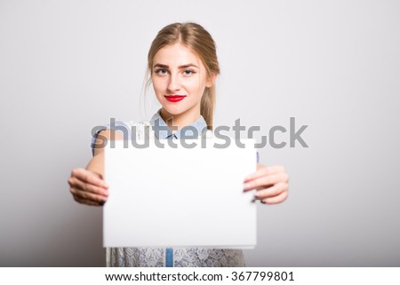 blonde girl holding a blank sheet of paper, isolated