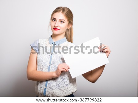 blonde girl holding a blank sheet of paper, isolated