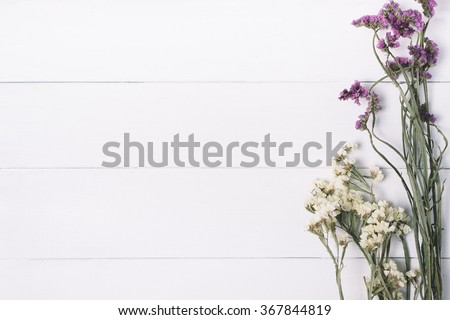 Bouquet of dried wild flowers on a white background of vintage wooden planks top view horizontal

