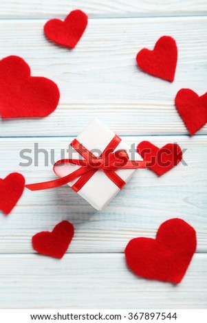 Love hearts with gift box on a blue wooden table