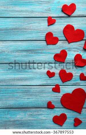 Red hearts on a blue wooden table