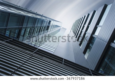 underside panoramic and perspective view to steel blue glass high rise building skyscrapers, industrial architecture Royalty-Free Stock Photo #367937186