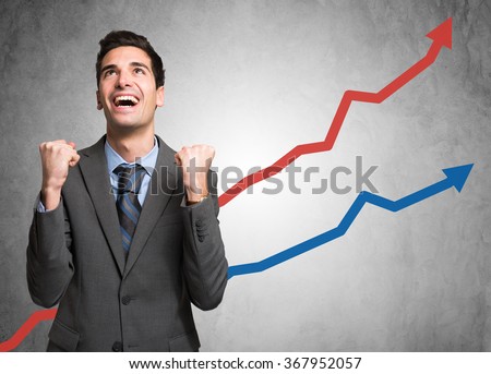 Portrait of an happy businessman standing in front of rising arrows Royalty-Free Stock Photo #367952057