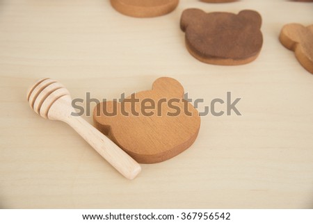 tiny cute wooden unface bear tray and honey stick on wooden table