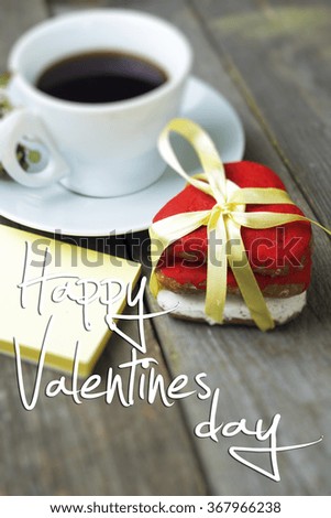 Romantic breakfast on Valentine's Day. Cup of coffee and heart shape cookies, white rose decoration. Happy Valentines day message. blury background image
