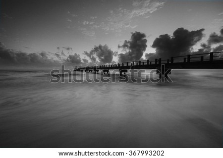 black and white long exposure shot of "Kijal Jetty" during sunrise.Soft focus due to long exposure.