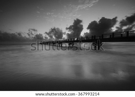 black and white long exposure shot of ''Kijal Jetty'' during sunrise.Soft focus due to long exposure.