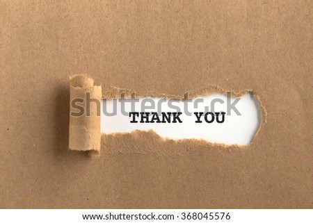 The text THANK YOU behind torn brown paper Royalty-Free Stock Photo #368045576