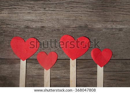 Red heart made of paper on wooden background