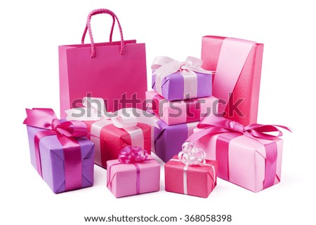 A collection of pink and purple Valentine's gifts with satin ribbons.