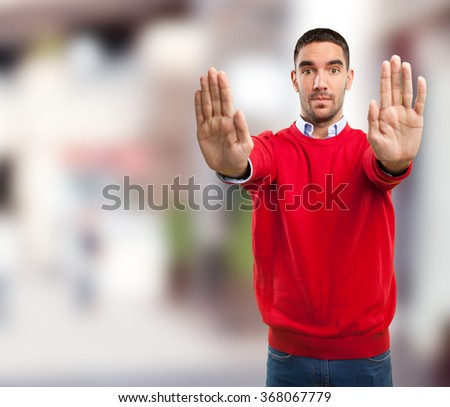 Young man stop gesture