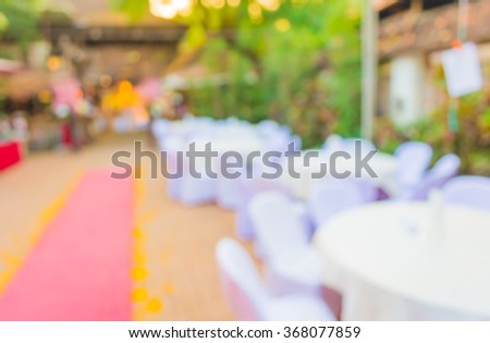 blur image of Tables and decoration prepared for an outdoor party for background usage.