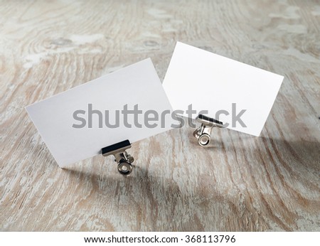 Blank business cards on light wooden background. Template for ID. Mock-up for branding identity.