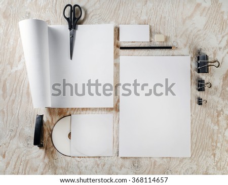 Photo of blank stationery and corporate identity template on light wooden background. Template for design presentations and portfolios.