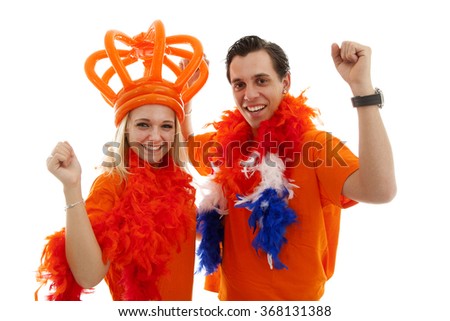 Couple of Dutch soccer supporters cheer over white background
