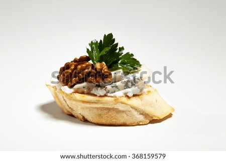 Sandwich with blue cheese, walnut and parsley on the grey background