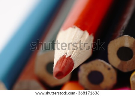 Colorful wooden pencils. Different than other. Creative mess on the table cartoonist.