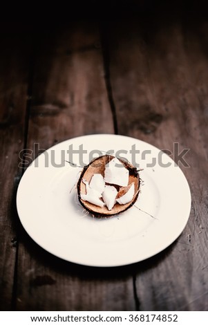		Coconut pieces on dark wooden background with copy space  for text
