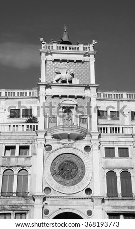 St Mark's Clocktower with Zodiac clock and Winged Lion. Piazza San Marco in Venice (Italy). Aged photo. Black and white.