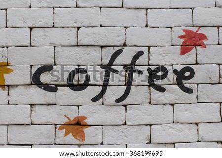 Colorful word "Coffee" on a white wall.