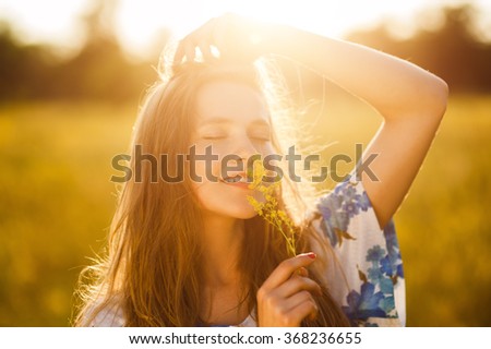 Beautiful girl on the flowers field Beautiful blonde,Healthy Lifestyle woman in the flowers field on sunset  Soft focus,Summer scenes