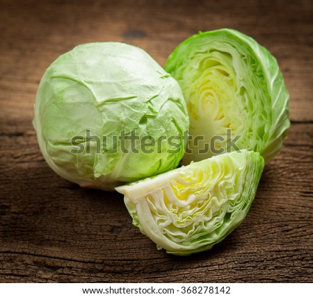 cabbage and cutted cabbage on wooden Royalty-Free Stock Photo #368278142