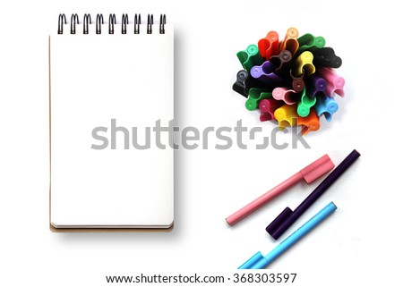 Blank spiral notebook with colorful markes on a white table. Artist, designer desktop view mockup.