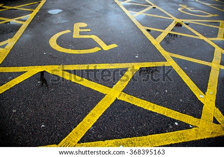 Yellow disable parking road sign marking on tarmac