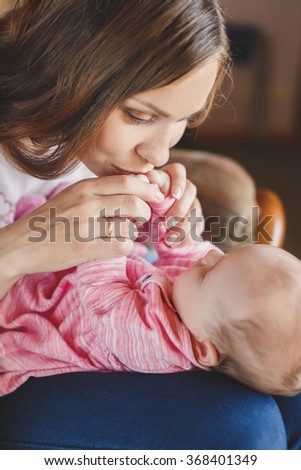 Young mother and her sleeping baby girl of 3 months. loving mother kissing her baby. Mom With her Child. Happy Family. woman with baby. 
