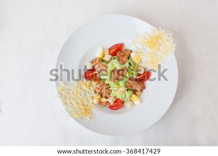 Caesar salad with grilled chicken and parmesan crisps on a plate on top of a white background isolated beautiful series menu