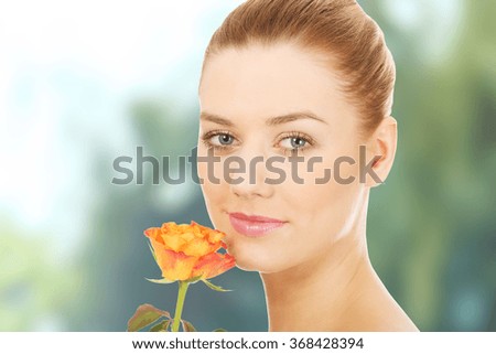 Smiling woman with fresh rose.