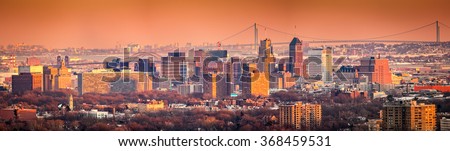 Newark New Jersey skyline viewed from Eagle Rock reservation under an orange sunset.