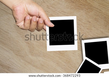 Blank instant photo in man's hand - place your own picture on it. 