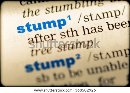 Close-up of word in English dictionary. Stump, definition and transcription